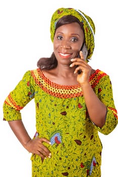 beautiful African adult woman wearing a green loincloth is phoning followed by a beautiful smile