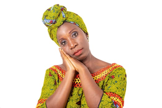 Beautiful african adult woman wearing a loincloth and scarf with green head on isolated white background posing both hands together