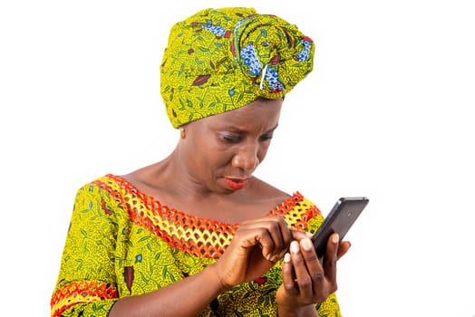 beautiful african adult woman wearing a loincloth and green scarf manipulates her cellphone black