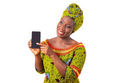 beautiful african adult woman dressed in loincloth and green scarf is happy showing her phone