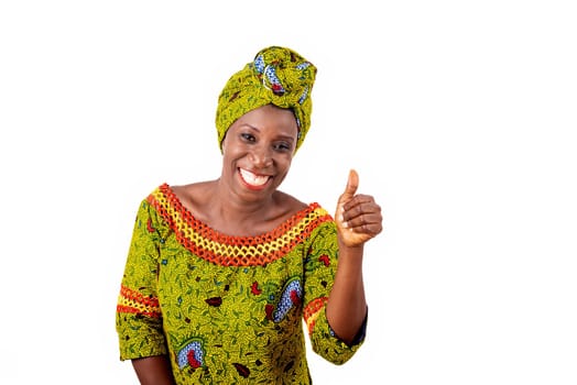 beautiful african adult woman dressed in loincloth and green scarf is happy showing thumbs up with hand