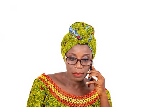 beautiful mature woman in eyeglasses isolated on white background communicating to mobile phone.