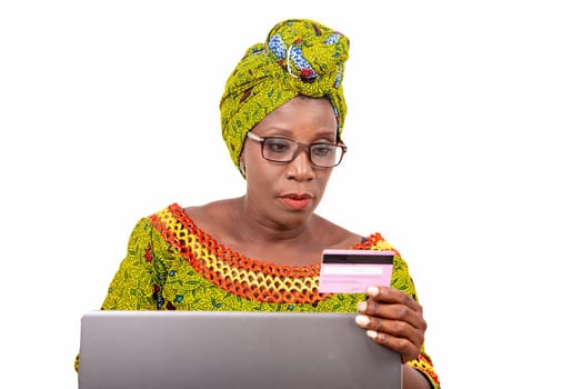beautiful mature woman in eyeglasses isolated on white background doing online shopping.