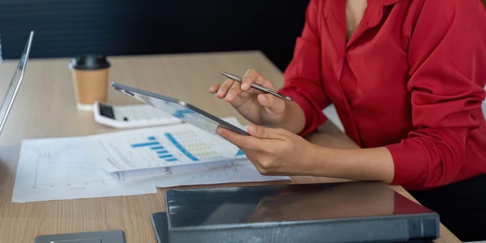 During a business meeting, a colleague evaluates detailed charts on a tablet, incorporating insights to drive informed decisions about financial strategies.