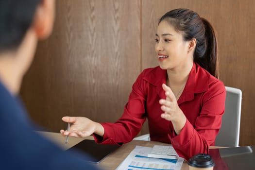 A financial consultant explains insights from a report to a client, fostering a collaborative environment.