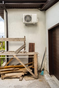 Wooden frames under white air conditioner. Practical home improvement and resourceful construction methods and care.