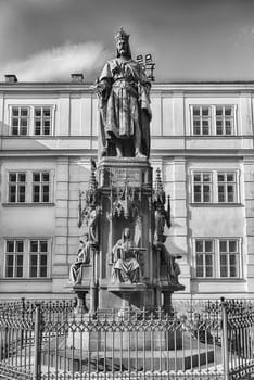 Bronze statue of Charles IV, holy roman emperor, standing tall in Prague, Czech Republic with a bright blue sky