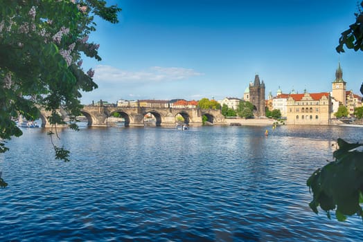 Charles Bridge crossing the Vltava River on a sunny day with the buildings of old town in the background in Prague, Czech Republic