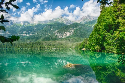 Panoramic view of the beautiful Lake Tovel with the Brenta Dolomites in the background on a sunny summer day, Trentino Alto Adige, Italy