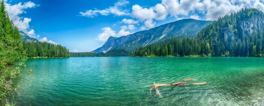 Panoramic view of the beautiful Lake Tovel with the Brenta Dolomites in the background on a sunny summer day, Trentino Alto Adige, Italy