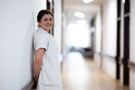 A tired nurse takes a quiet moment to rest in the hospital hallway, reflecting on a long and demanding shift