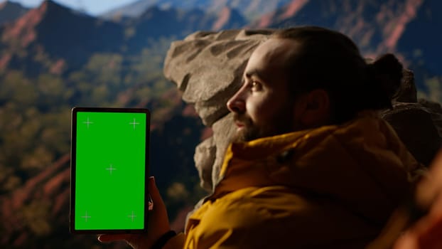 Climber admires breathtaking mountain peak with copy space screen, joyous stance embodies determination, endurance, and the personal fulfillment that comes with overcoming challenges. Camera B.