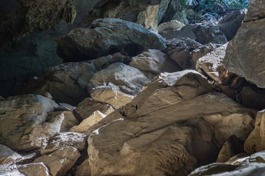 Uthai Thani, Thailand - 06 Dec, 2024 - The intricate sunlight shining through down to Stalagmites inside Cave of Hup Pa Tat. The famous travel in the Central Valley Uthai Thani, use it as your Wallpaper, Poster and Space for text, Selective fosus.