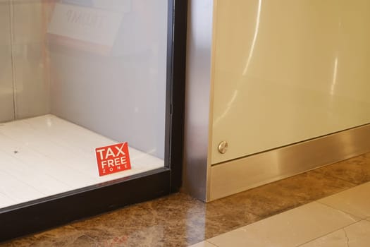 A tax free zone sign is visible in a retail space corner.
