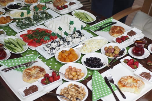 A vibrant breakfast table filled with diverse dishes and colorful fruits.
