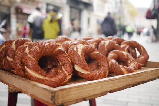 Freshly baked turkish simit displayed in a busy market street,