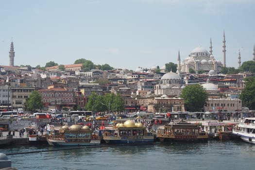 Colorful boats are moored at the docks near Istanbul, showcasing the skyline.
