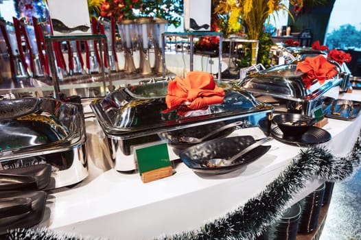 hot dishes in trays on the buffet table in the self-service restaurant at the hotel in the resort