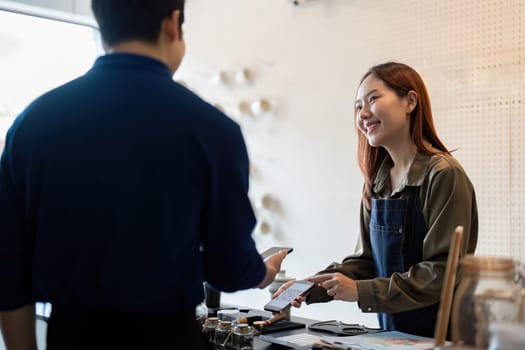 A barista enthusiastically discusses sustainable choices with a customer, promoting eco-friendly practices while enhancing the cafe experience.