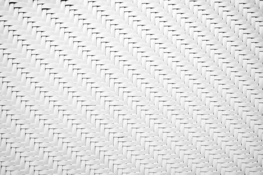 white background with artificial texture of woven rattan. Abstract braided plastic pattern