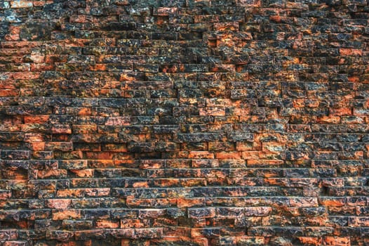 texture of an ancient old historical brick wall. Vintage background with weathered structure