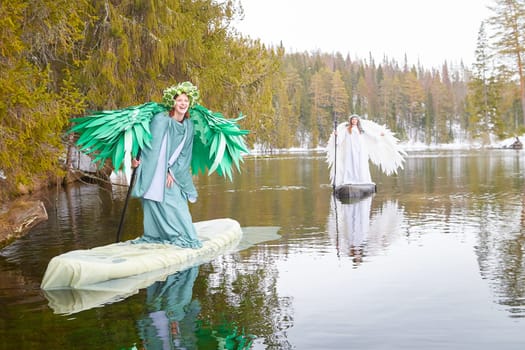 Two girls dressed in white and green gather on a tranquil lake, embodying the transition between winter and spring in a whimsical role-playing scene.