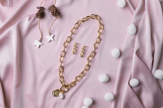 Women's Jewelry. Trendy jewelry on silk background. Flat lay, top view