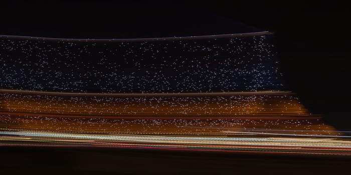 Paris, France - February 24, 2025: the view of illuminated Eiffel Tower at night as streaks of light fill the scene, captured in motion with long exposure. Creative dynamic romantic background