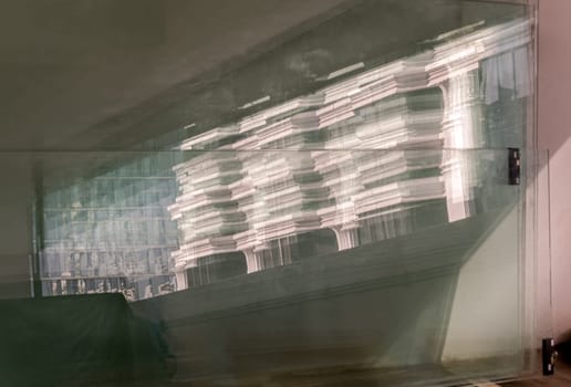 Bangkok, Thailand 23 Dec, 2024 - View of Modern building pattern on reflective plate glass leaning against the cement wall. Reflection of the building in the mirrored surface, use it as your Wallpaper, Poster and Space for text, Selective focus.