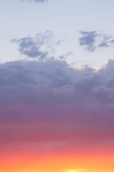 Brilliant shades of orange and pink spread across the evening sky.