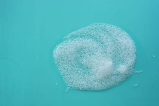 Bubbles gather on a turquoise surface, showcasing a fresh, clean atmosphere.