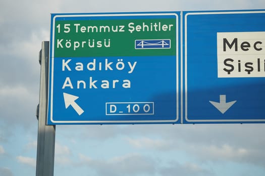 Road sign guides travelers towards Kadikoy and Ankara on a clear day.