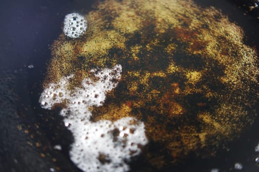 old cooking oil in a cooking pan .