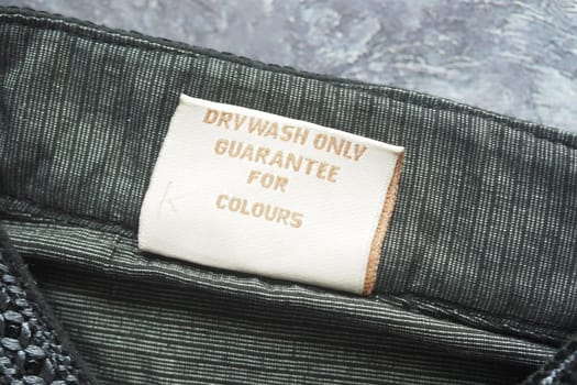 Care label stresses dry wash only to maintain vibrant colors in fabric.