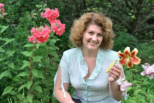Woman in garden surrounded by a flowers