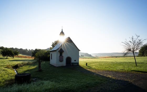 Small Finten Chapel close to Wittlich against sunrise, Rhineland Palatinate, Germany