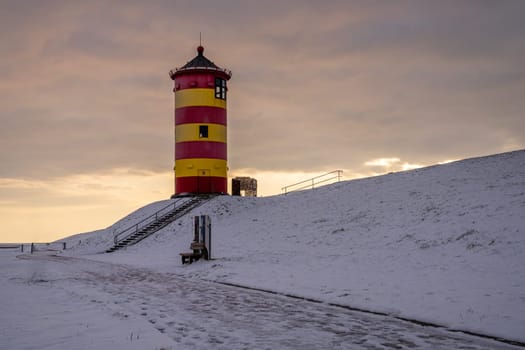 Pilsum, Germany - February 13, 2025: Lighthouse of Pilsum during sunset on February 13, 2025 in East Frisia, Germany