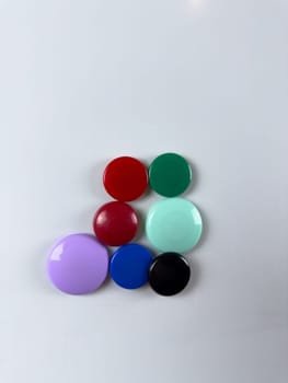 Group of magnets on whiteboard perfect for securing notes and reminders ideal for creating efficient task management systems in various settings