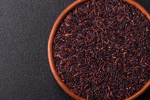 Red or brown raw rice in a ceramic bowl. Rice as an ingredient in Asian organic food