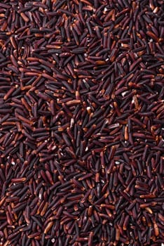 Red or brown raw rice in a ceramic bowl. Rice as an ingredient in Asian organic food