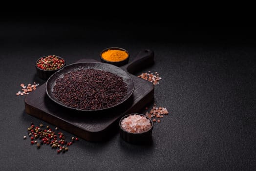 Red or brown raw rice in a ceramic bowl. Rice as an ingredient in Asian organic food