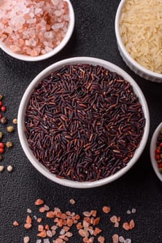 Red or brown raw rice in a ceramic bowl. Rice as an ingredient in Asian organic food