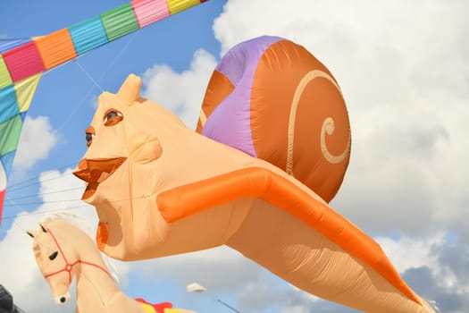 Kite festival. Kite snail in the sky at the beach of Atlantic ocean