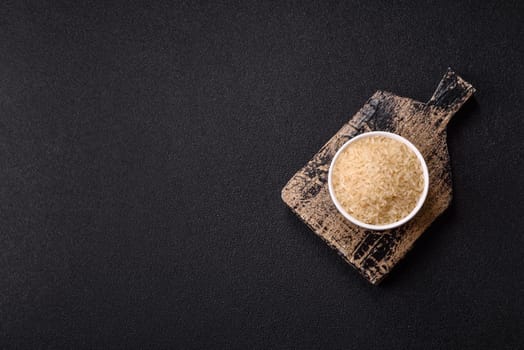 White raw rice in a ceramic bowl. Rice as an ingredient in Asian organic food