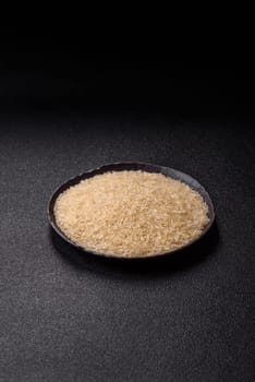 White raw rice in a ceramic bowl. Rice as an ingredient in Asian organic food