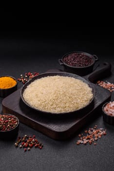 White raw rice in a ceramic bowl. Rice as an ingredient in Asian organic food