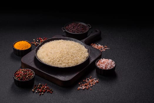 White raw rice in a ceramic bowl. Rice as an ingredient in Asian organic food