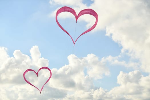 Pink hearts kites is flying in the sky