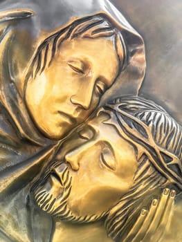 Jesus and Mary. Bronze statue of Mother Mary holding her son Jesus.