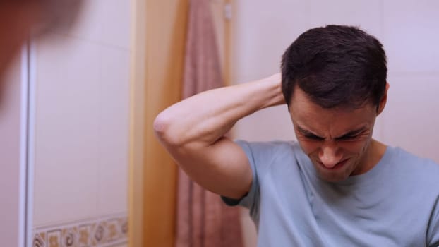 Man looking downcast and very worried in the bathroom